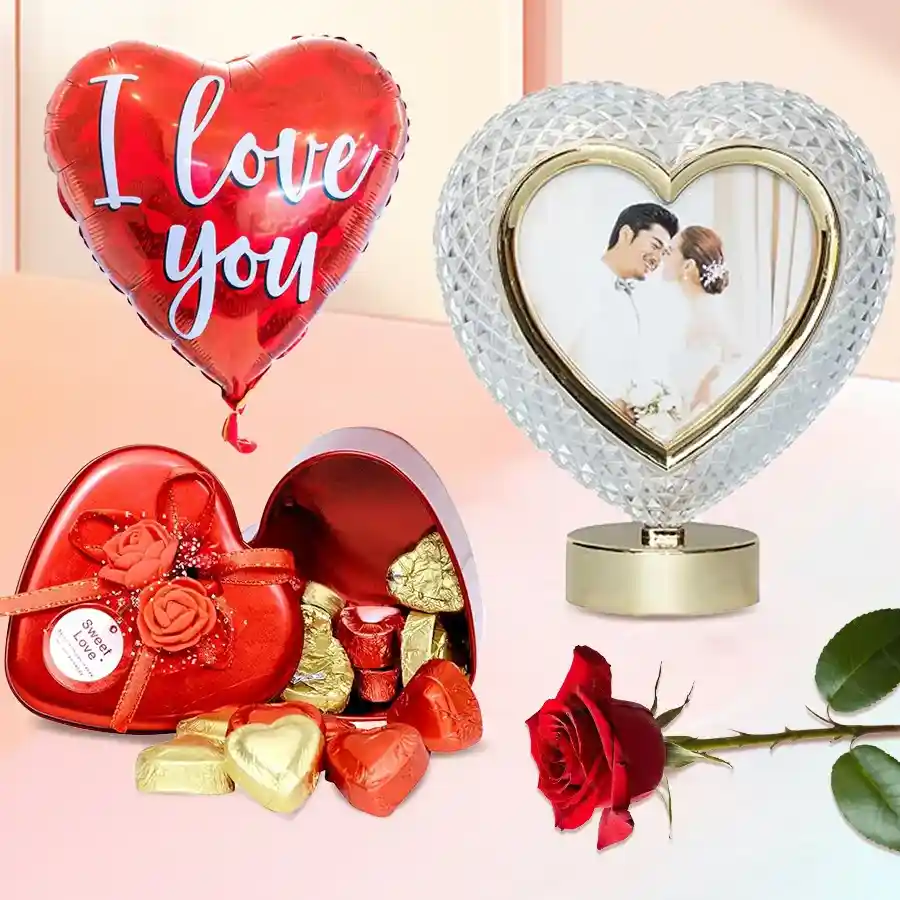Mesmerizing Personalized Gift Set including a custom Heart Shape Sub Crystal, a red rose, an "I Love You" Mylar balloon, and a Heart Shape Tin filled with 11 handmade chocolates.