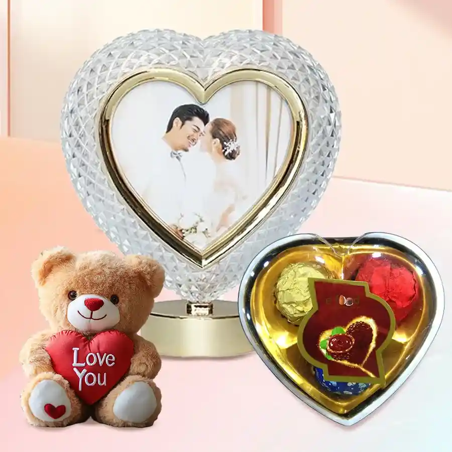 Personalized heart-shaped crystal with a custom photo, three heart-shaped chocolates, and a 9-inch teddy bear holding an "I Love You" heart.