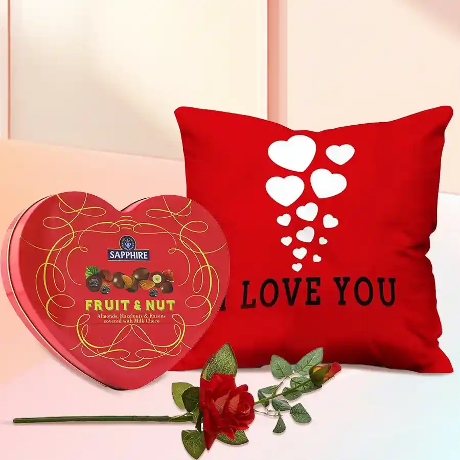 Personalized ILU heart cushion with Sapphire Heart chocolate box and velvet rose on a decorative background.