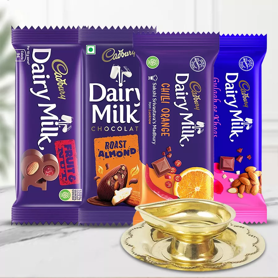 Piquant Cadbury Latest Edition Chocolates gift pack with a handcrafted Spillbox Brass Oil Lamp and assorted flavors of Dairy Milk chocolates, beautifully arranged for Diwali celebrations.
