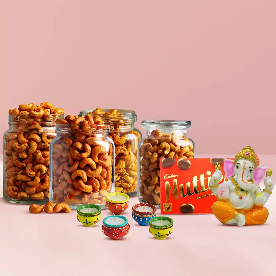 Blissful Pack of flavored cashews, Vighnesh Ganesh Idol, Cadbury Nutties, and five colorful Matka Wax Diyas arranged together for Diwali celebration.