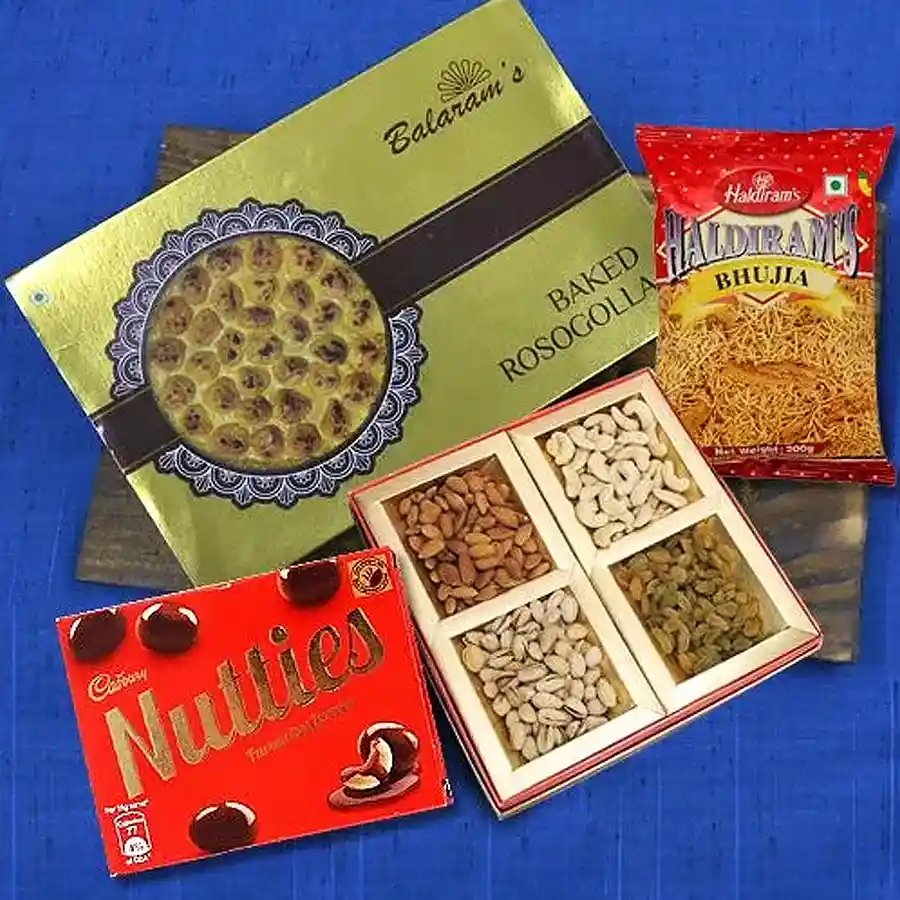 Special Balaram Mullick Diwali snack combo featuring baked rasgullas, assorted dry fruits, Haldiram bhujia, and Cadbury nutties, beautifully packaged