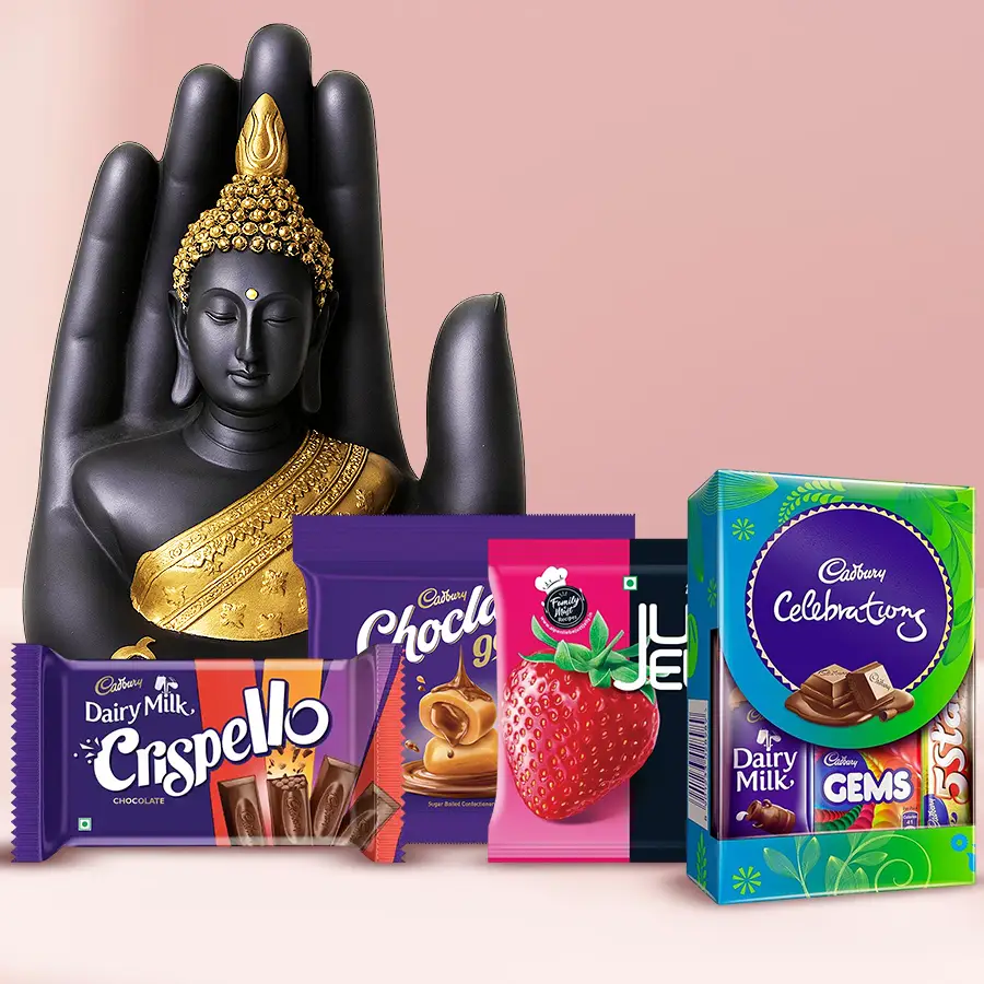 Artistic Palm Buddha Statue alongside a Cadbury Family Assortment of chocolates and sweets