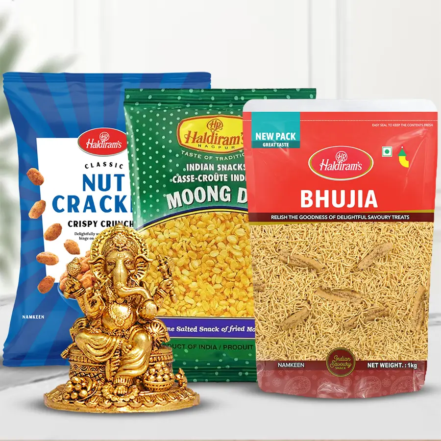 Elegant Brass Ganesha Dashboard Statue with Haldiram snacks including Bhujia, Moong Dal Fried, and Nut Crackers