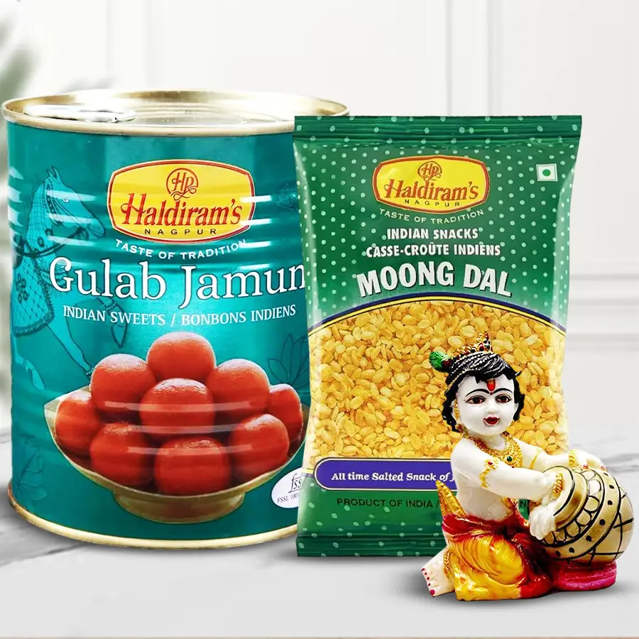 Hand-carved Baby Krishna resin sculpture alongside Haldiram snacks including Gulab Jamun and Moong Dal Fried, celebrating Diwali.