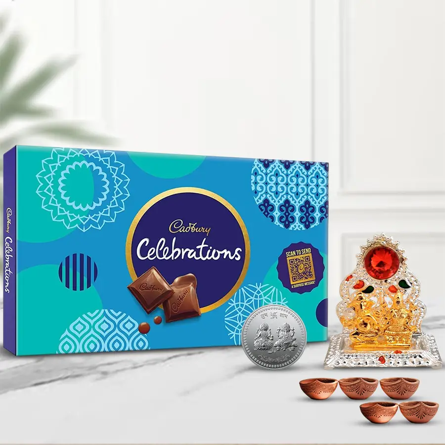 Pious Laxmi Ganesh Mandap gift box with Cadbury Celebration chocolates, Diyas, and a free coin for Diwali celebration.