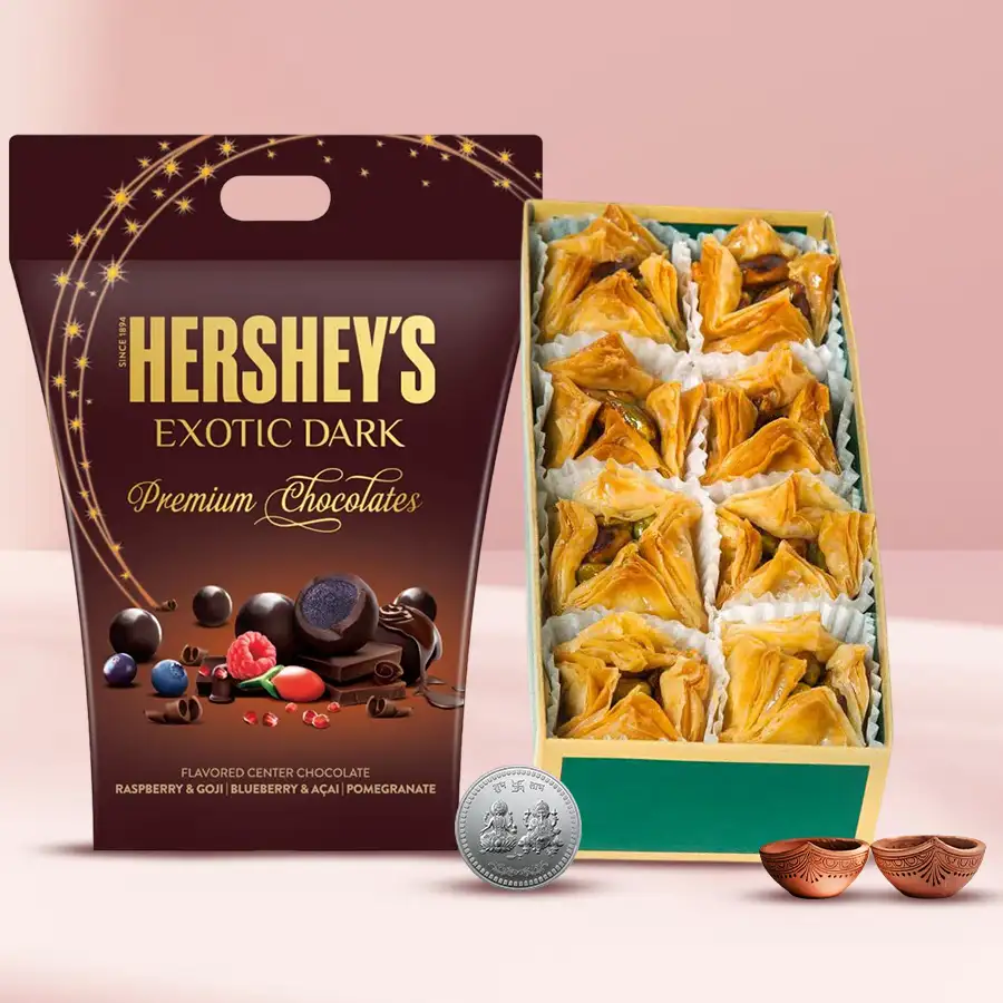 Finest Pyramid Baklawa with Hershey's Dark Chocolates, Ganesh Laxmi coin, and two diyas, arranged for Diwali celebration.