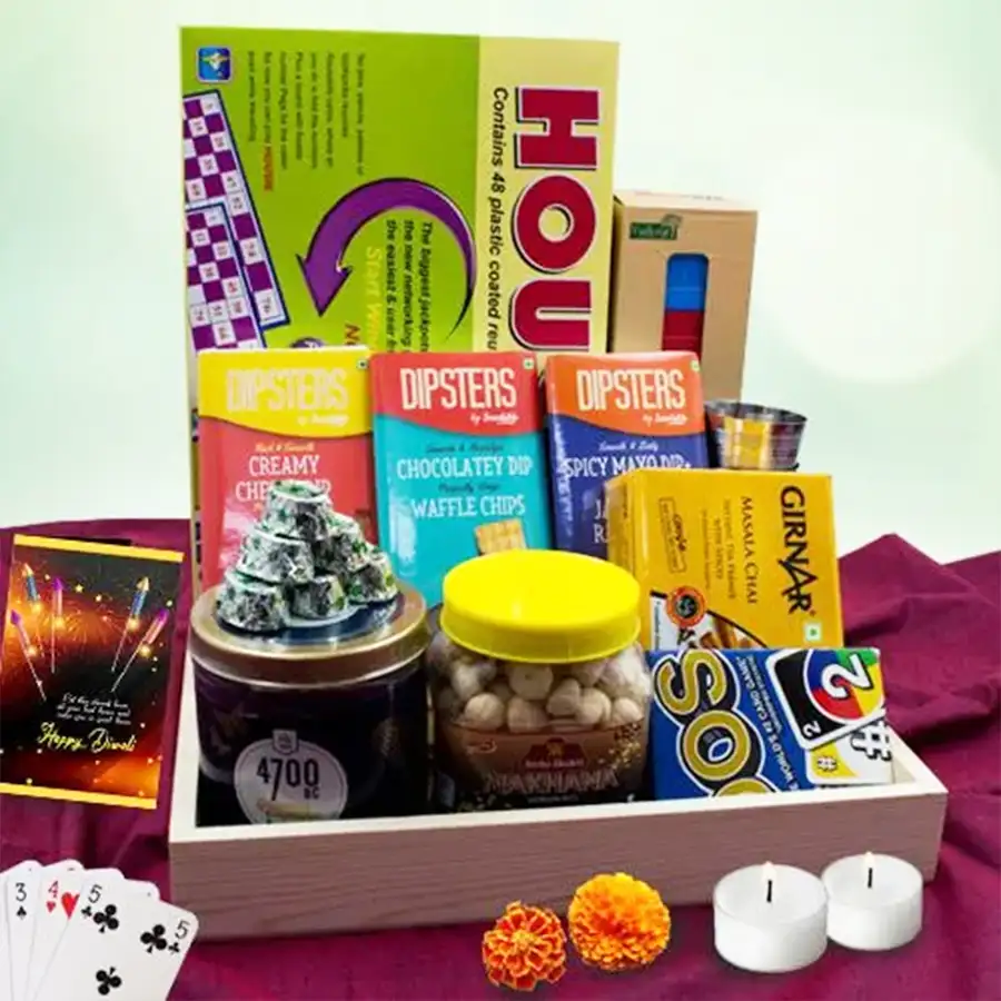 Classy UNO and Housie Game Night hamper for Diwali featuring popcorn, ragi chips, dips, handmade dark chocolate, masala chai in stainless steel glasses, and games in a wooden tray.