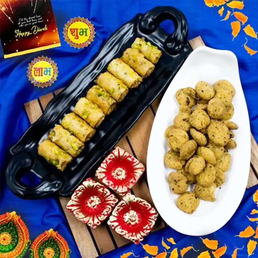 Lovely gift set featuring Roll Baklava, Haldiram Methi Mathri, and five decorative diyas for Diwali celebrations.