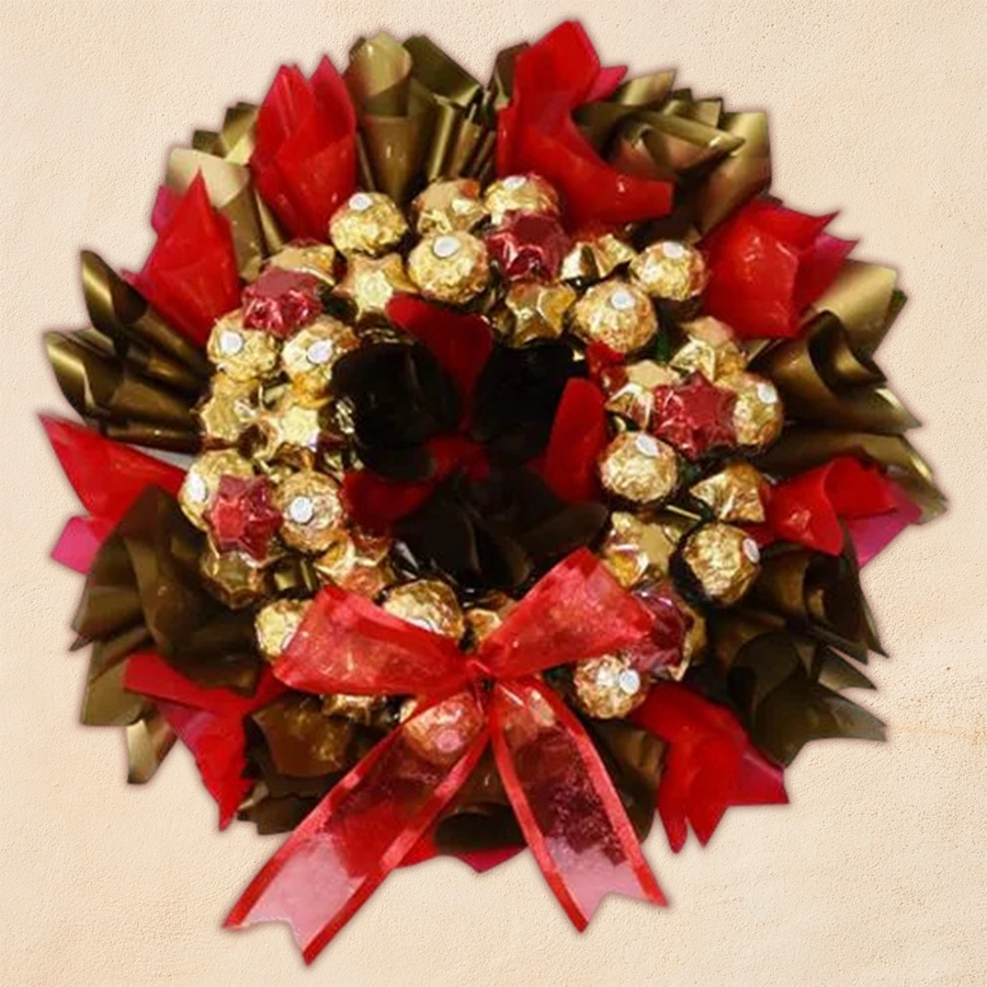 Homemade chocolate Xmas wreath decorated with various shaped chocolates arranged in a festive design