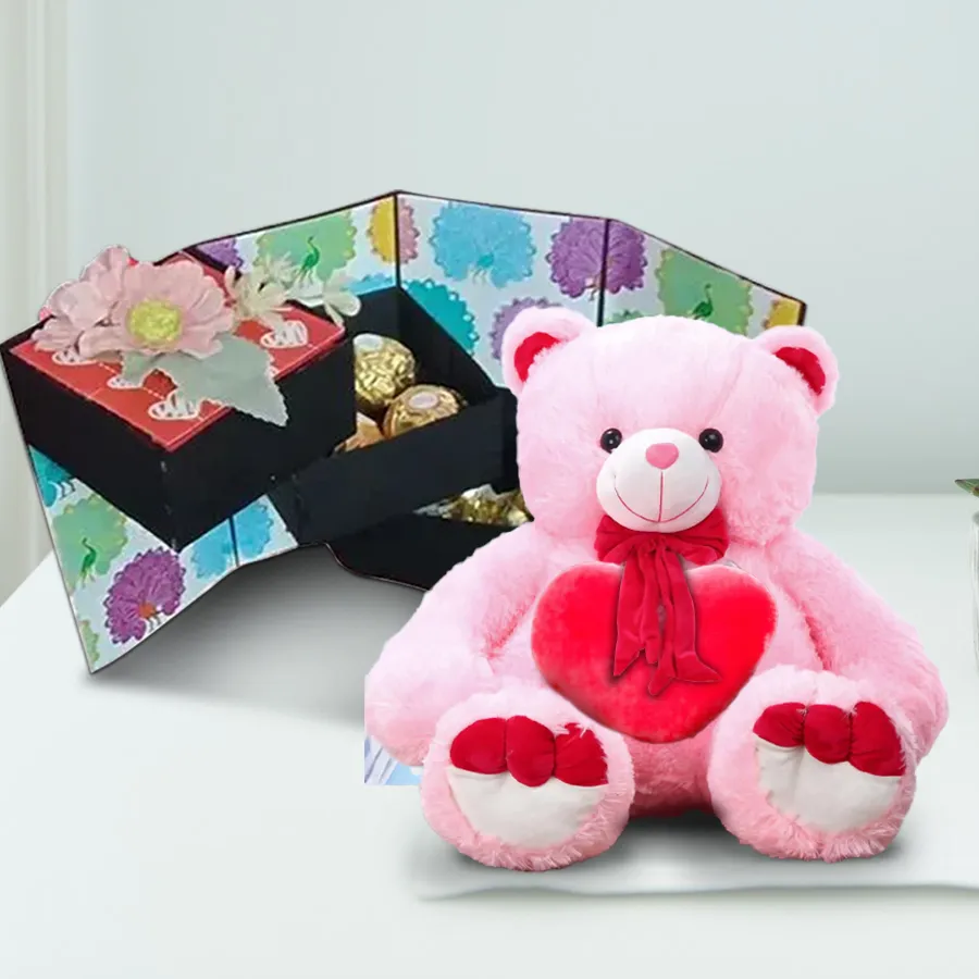 4-layer handmade stepper box filled with assorted chocolates and a teddy bear holding a heart