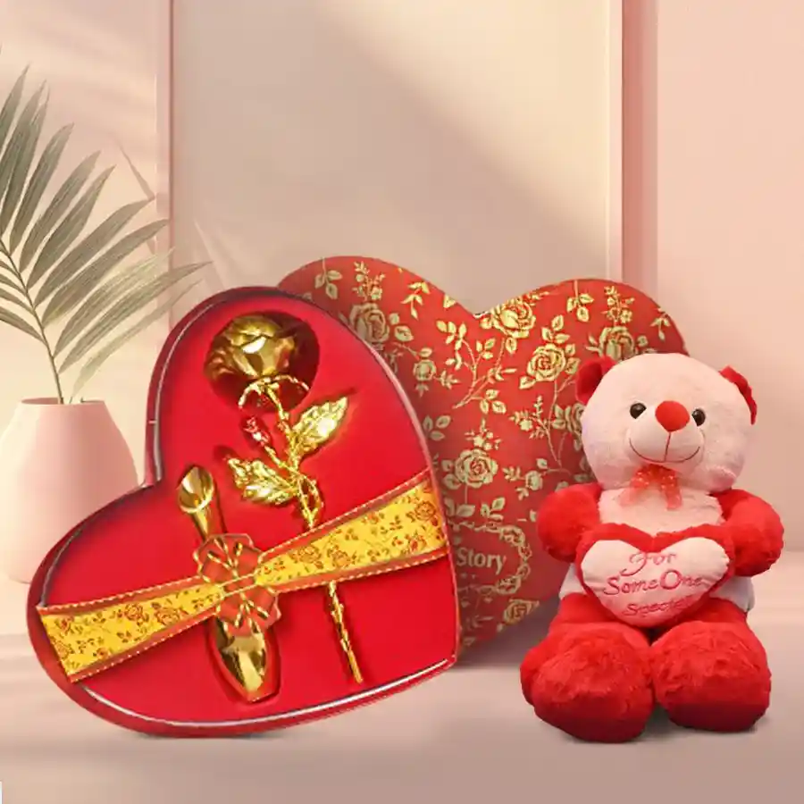 Spectacular combo featuring a cuddly 9-inch teddy bear holding a heart alongside a stunning golden rose in a heart-shaped box.