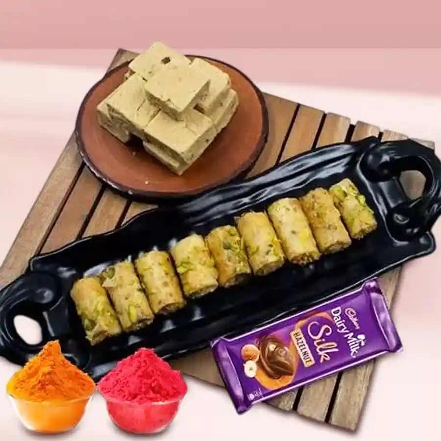 Sumptuous Kaju Bite with Baklawa and Cadbury Silk Chocolate for Holi celebration, featuring vibrant Herbal Gulal packets.
