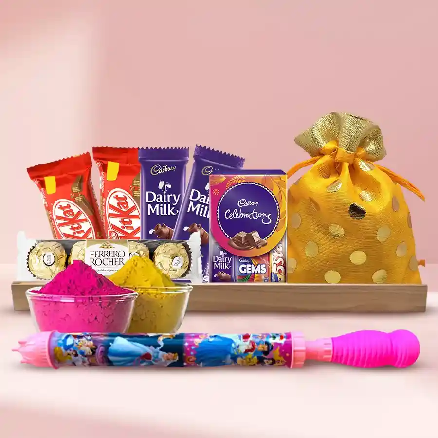 Holi special gift combo featuring chocolates, crunchy cashews, a long pitchkari, and herbal gulal arranged in a decorative tray.
