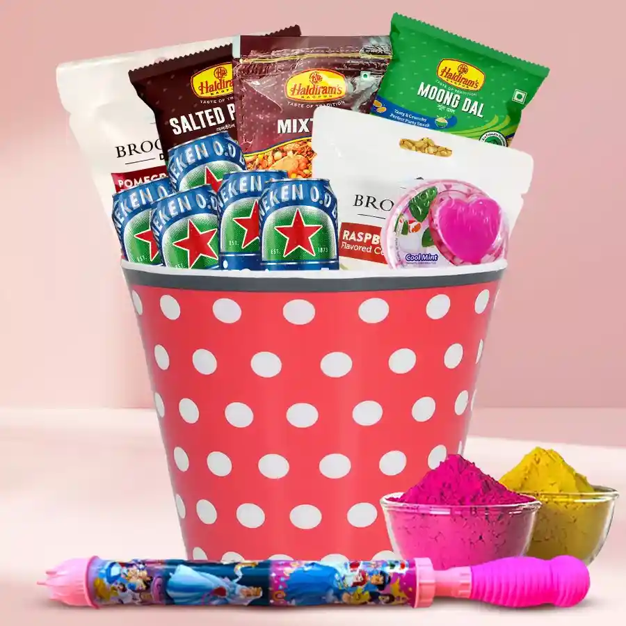 Impressive Gourmets Treat Basket with Holi accessories including drinks, candies, savory snacks, mint candies, peanuts, pitchkari, and herbal gulal in a designer bucket.