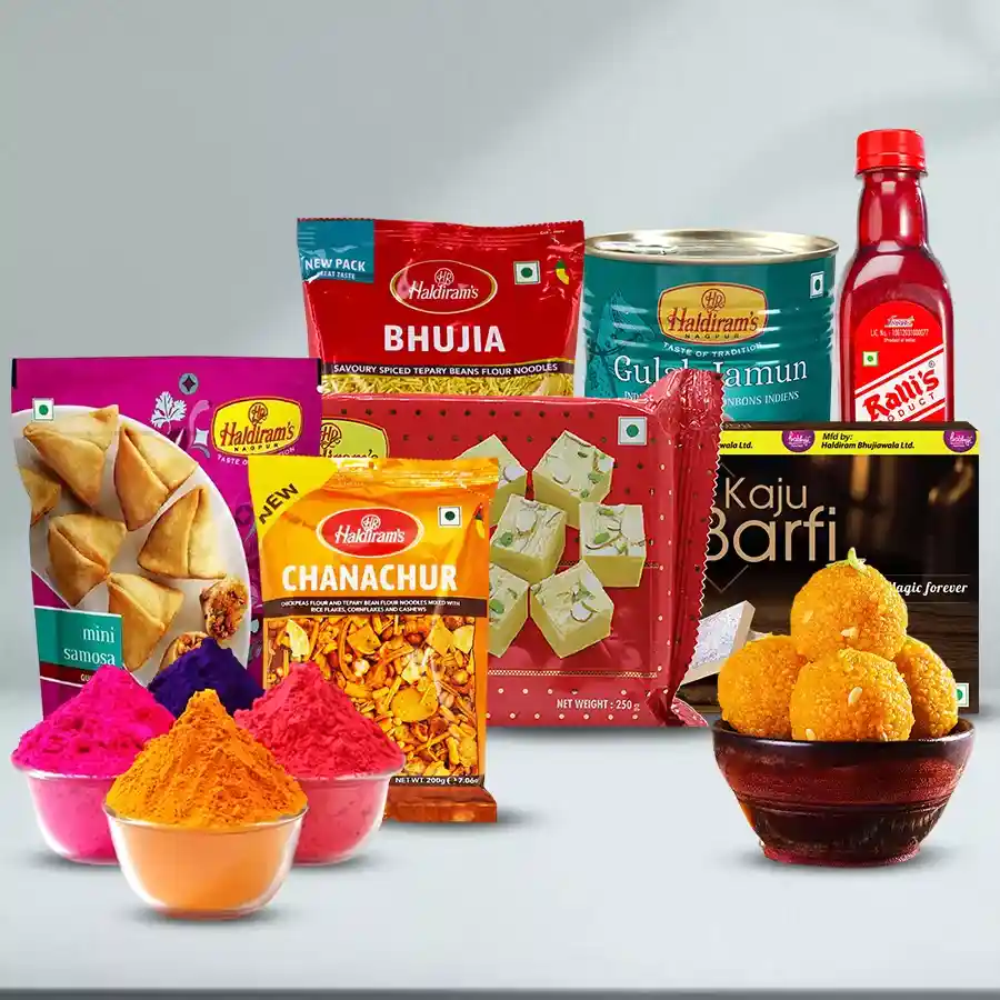 Gift box featuring Splendid Haldiram Delectables including Mini Samosas, Chanachur, Soan Papdi, Kaju Barfi, Bhujia, Laddu, and Gula Jamun, accompanied by vibrant Herbal Gulal for Holi celebrations.