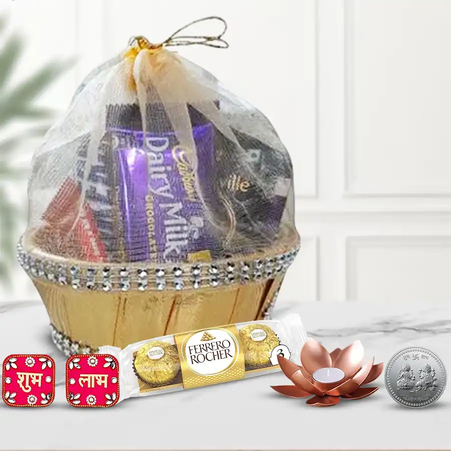 Festive Hamper featuring Ferrero Rocher chocolates, Shubh Labh wall sticker, tea light candle holders, and a silver-plated Ganesh Laxmi coin in a decorative gift basket.
