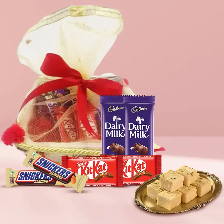 Gift basket filled with Diwali sweets and chocolates, including Soan Papdi, Cadbury Dairy Milk bars, Nestle KitKats, and Snickers Almond bars.