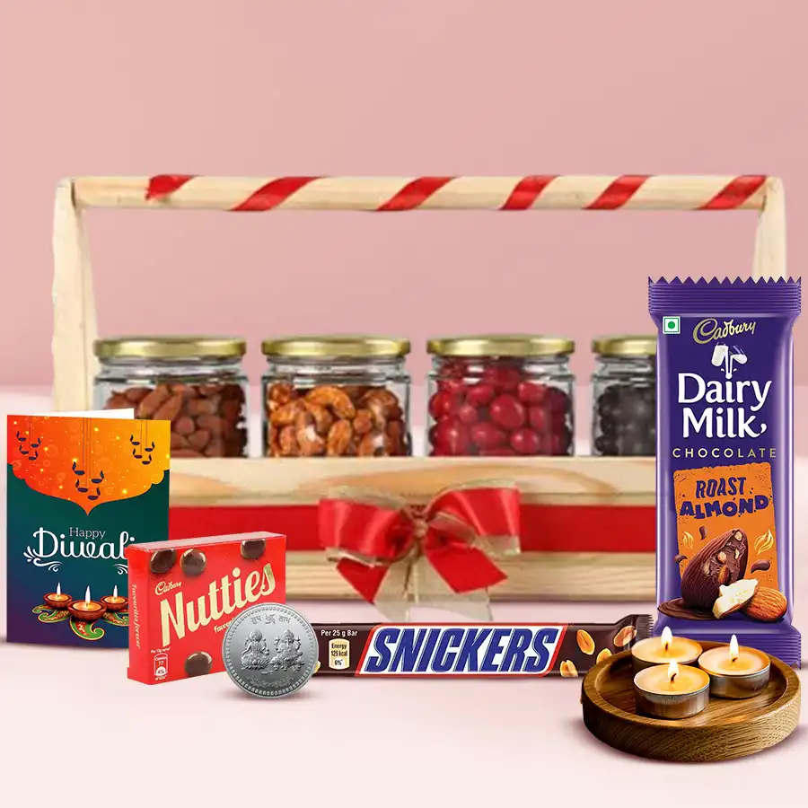 Luxurious Diwali gift basket featuring dried fruits, chocolates, tea light candles, a silver-plated Ganesh Lakshmi coin, and a Diwali greetings card.