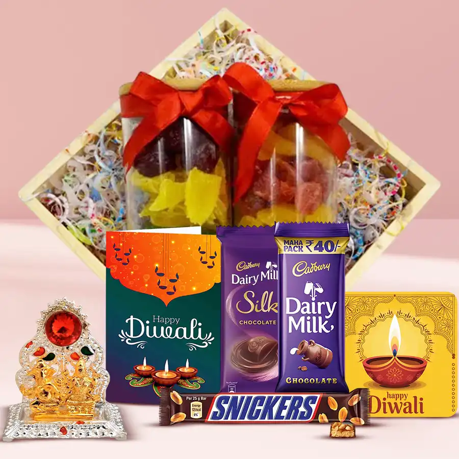 Beautiful wooden tray filled with assorted nuts, dried fruits, Cadbury Dairy Milk Silk chocolates, Snickers, a Ganesh Laxmi Mandap, a handmade fridge magnet, and a Diwali wishing card, arranged elegantly for the festive season.