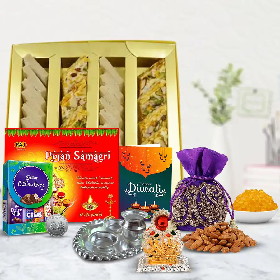 Elegant Diwali Gourmet Gift Hamper featuring dry fruit, Kaju Barfi, Cadbury Dairy Milk, almond potli, silver Pooja Thali, Ganesh Laxmi Mandap, Pooja Samagri, beautifully wrapped with a Diwali card.