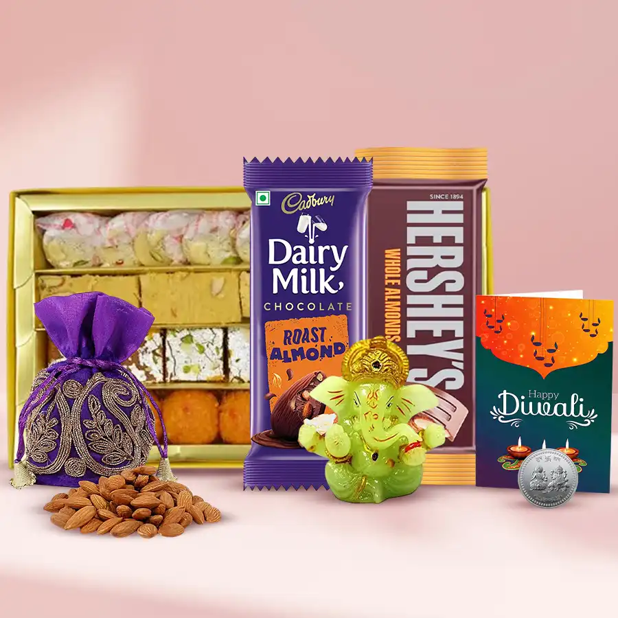 Festive Essence Deluxe Gift Box with Kesar Laddoos, Soan Papdi, Bhujia, Cadbury and Hershey’s almond chocolates, Ganesh idol, silver-plated Ganesh Lakshmi coin, almond potli, and a Diwali card