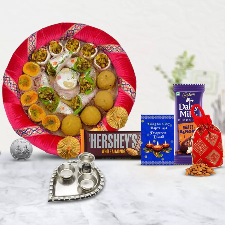 Unspoken Words Diwali Gift Hamper featuring sweets, chocolates, a Ganesh Laxmi coin, a pooja thali, and a Diwali card