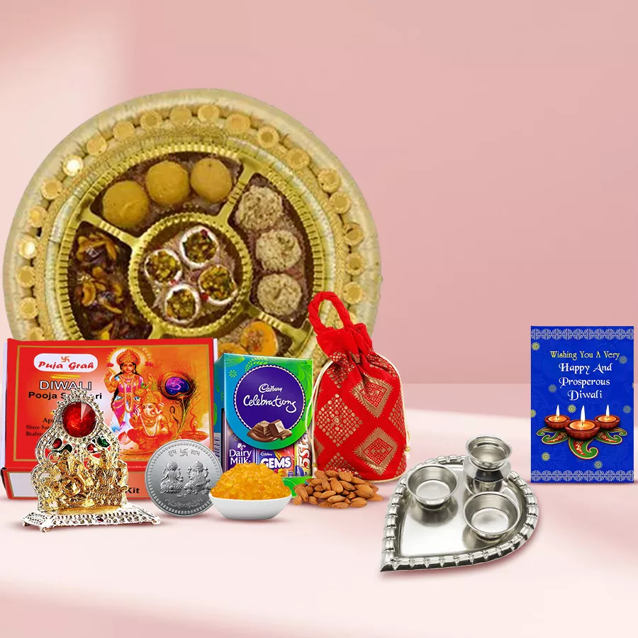 True Diwali Feelings Gift Hamper featuring mixed sweets, Cadbury Dairy Milk Celebration box, almonds, pooja items, Ganesh Lakshmi Mandap, silver paan-shaped thali, and a Diwali card.