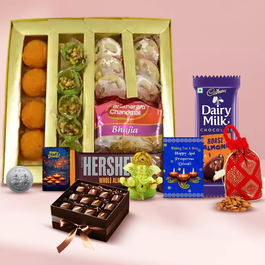 Joyful Celebration Gift Hamper featuring Mawa Tikiya, Kesar Laddoos, Cadbury and Hershey's chocolates, almond snacks, Bhujia, a Ganesh idol, a handcrafted fridge magnet, and a Diwali card, all beautifully packaged for the festive season.
