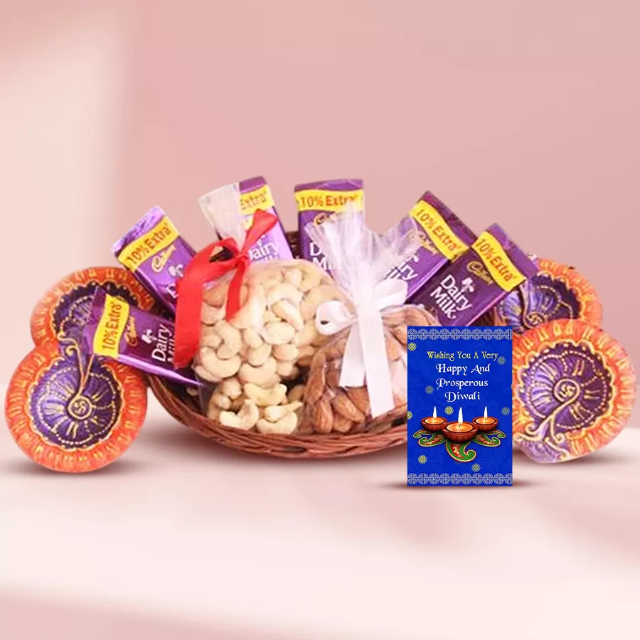Diwali Delights cane basket filled with cashews, almonds, Cadbury chocolates, and decorative diyas with a wishing card