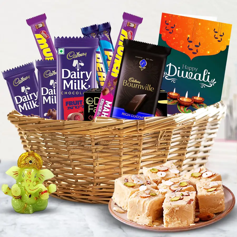 Grand Celebrations Diwali Hamper featuring an assortment of chocolates, sweet Soan Papdi, a glowing Ganesh, and presented in a reusable wooden basket with a Diwali wishing card.