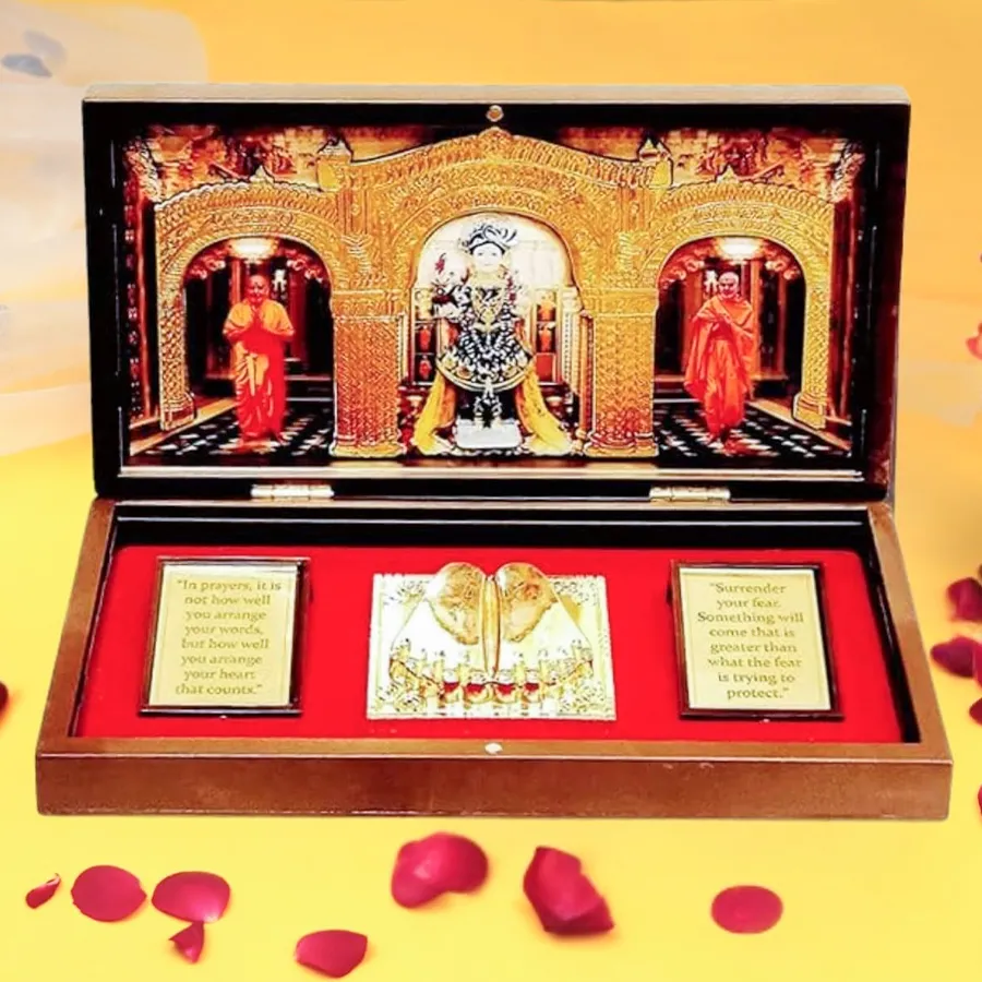 Auspicious Swaminarayan photo frame with Charan Paduka in a gold-plated finish and multicolor design, displayed on a tabletop.