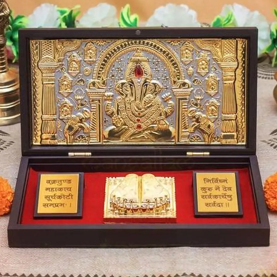 Gold plated Ganesha photo frame with Charan Paduka, showcasing a vibrant design and crafted from quality wood, measuring 11.5 cm x 21 cm.