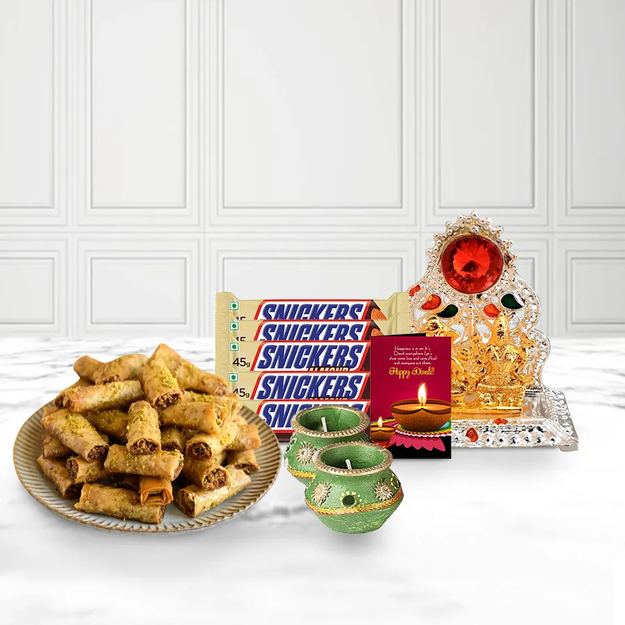 Heavenly Roll Baklava gift basket with Choco Snickers, decorated wax diyas, and Ganesh-Laxmi mandap, featuring a personalized Diwali card.