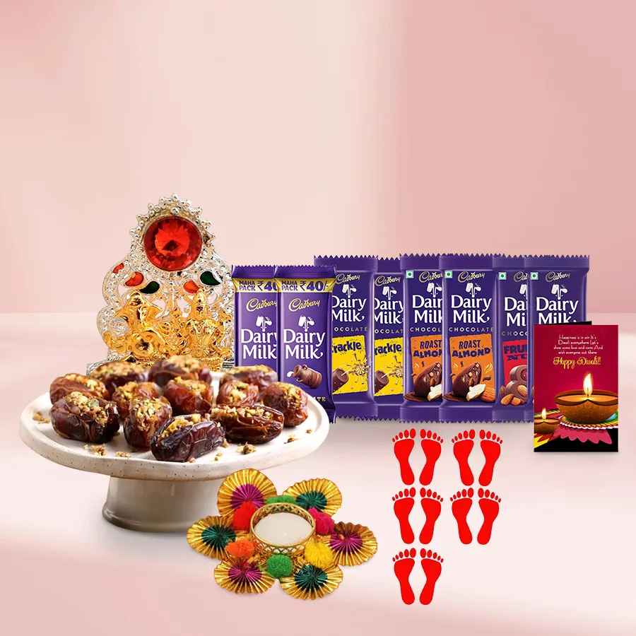 Gift basket featuring Lovely Dates Baklava, assorted Cadbury Chocolates, Ganesh Laxmi Mandap, tea light candle holder, Laxmi Charan Paduka stickers, and a Diwali card, all arranged in a decorative basket.