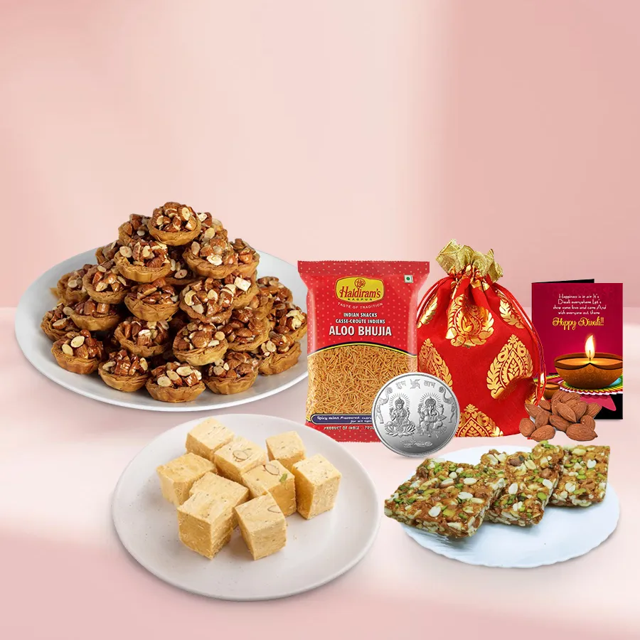 Enchanting Tart Baklava Basket with Tart Baklava, Soan Papdi, Bhujiya, Dry Fruit Chiki, almonds, Ganesh Lakshmi coin, and a Diwali card.