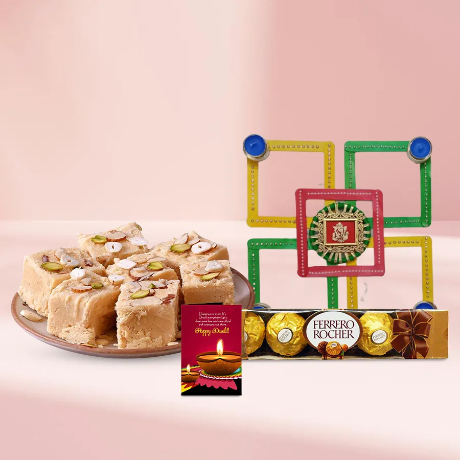 Diwali Bliss Goodies Box featuring Soan Papdi, a designer candle, a traditional diya, vibrant rangoli, Ferrero Rocher chocolates, and a Diwali greeting card