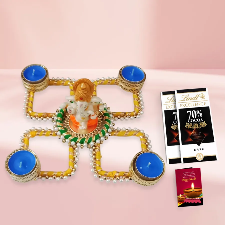 Happy Moments Diwali Gift Hamper featuring decorative pearls, a Ganesh Rangoli, glowing Diyas, Lindt chocolate bars, and a Diwali wishing card.