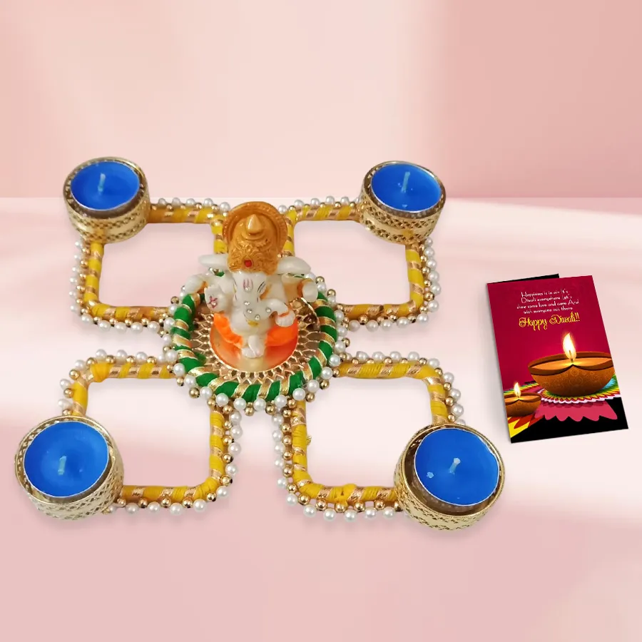 Beautiful Pearl and Ganesh Rangoli set with four colorful diyas and a Diwali wishing card