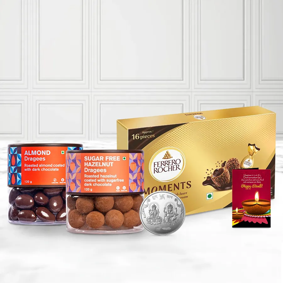 Gift basket featuring sugar-free hazelnut and almond dragees, Ferrero Rocher Moments, a silver-plated Ganesh Laxmi coin, and a festive Diwali card.