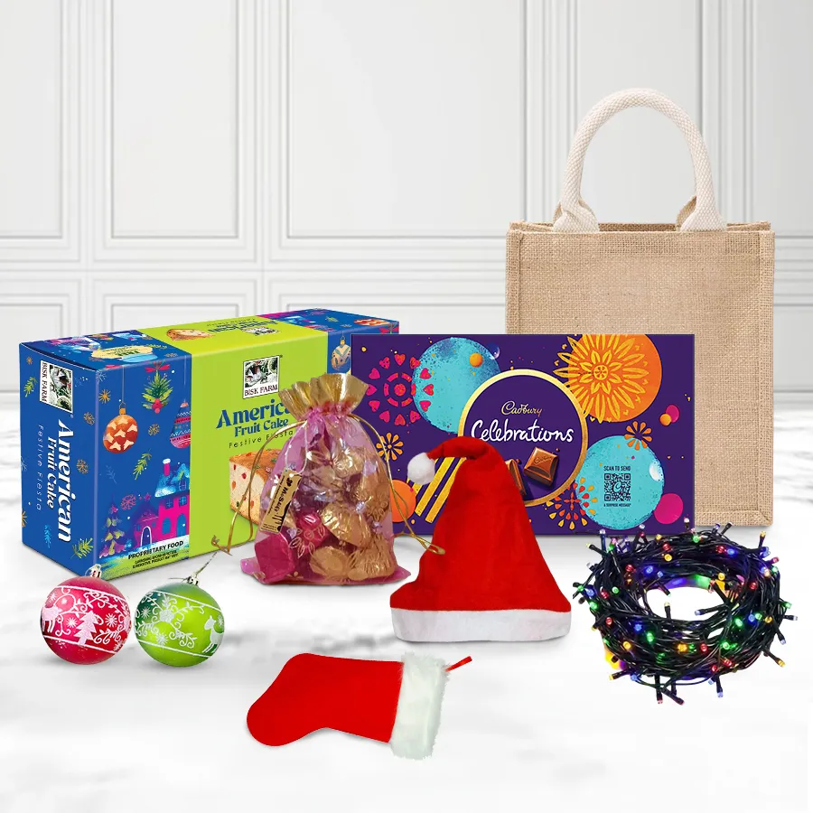 A beautifully arranged Christmas hamper featuring a rich fruit cake, Cadbury Celebrations, handmade chocolates, festive decorations, X-Mas lights, a cozy cap, and stockings, all presented in a jute bag.