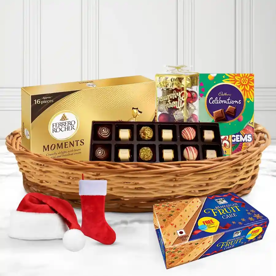 Christmas basket filled with a rich fruit cake, handmade chocolates, Ferrero Rocher, Cadbury Celebration Minis, festive decorations, a Christmas cap, stockings, and a reusable cane basket.