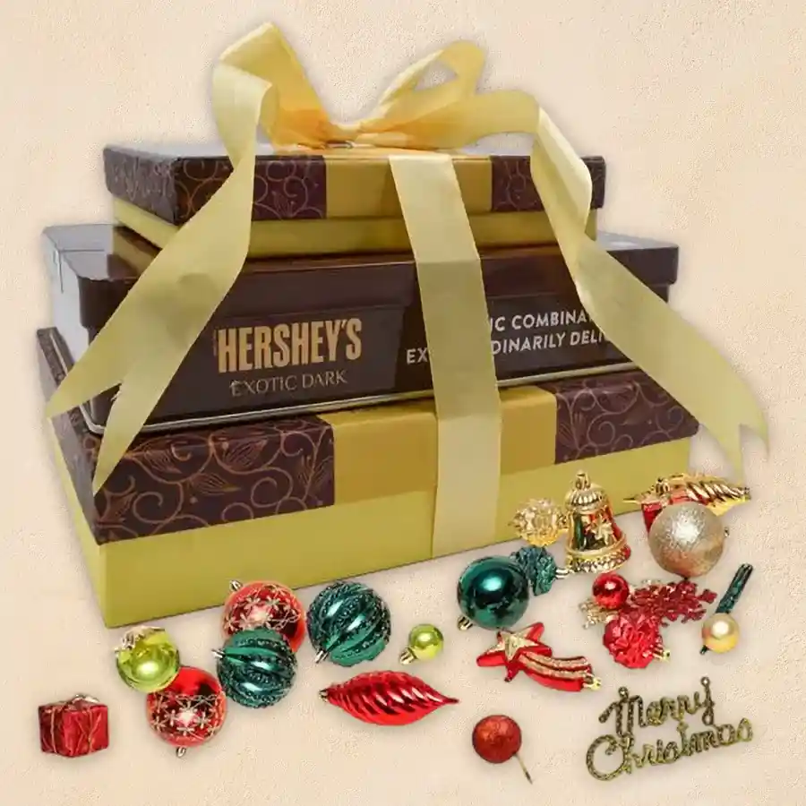 Sumptuous Choco N Nuts Tower arrangement featuring Hershey's Kisses, assorted dried and salted nuts, and festive decoration