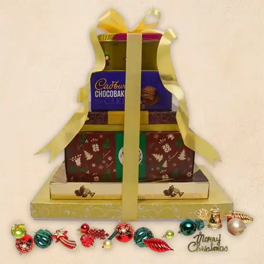 Delightful Xmas Special Gourmet Treat Tower featuring festive treats like American Fruit Cake, Luxure Truffle Chocolates, Ferrero Rocher Moments, Cocktail Nuts, Sapphire Butter Cookies, Malkist Crackers, Cadbury Chocobakes, and Sapphire Fruit & Nut Chocolate Coated treats in a decorative box.
