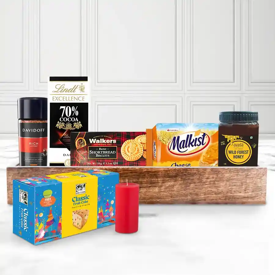 Munchy Gourmet Treat Christmas Hamper filled with coffee, chocolate, cookies, crackers, honey, fruit cake, a candle, and a wooden tray