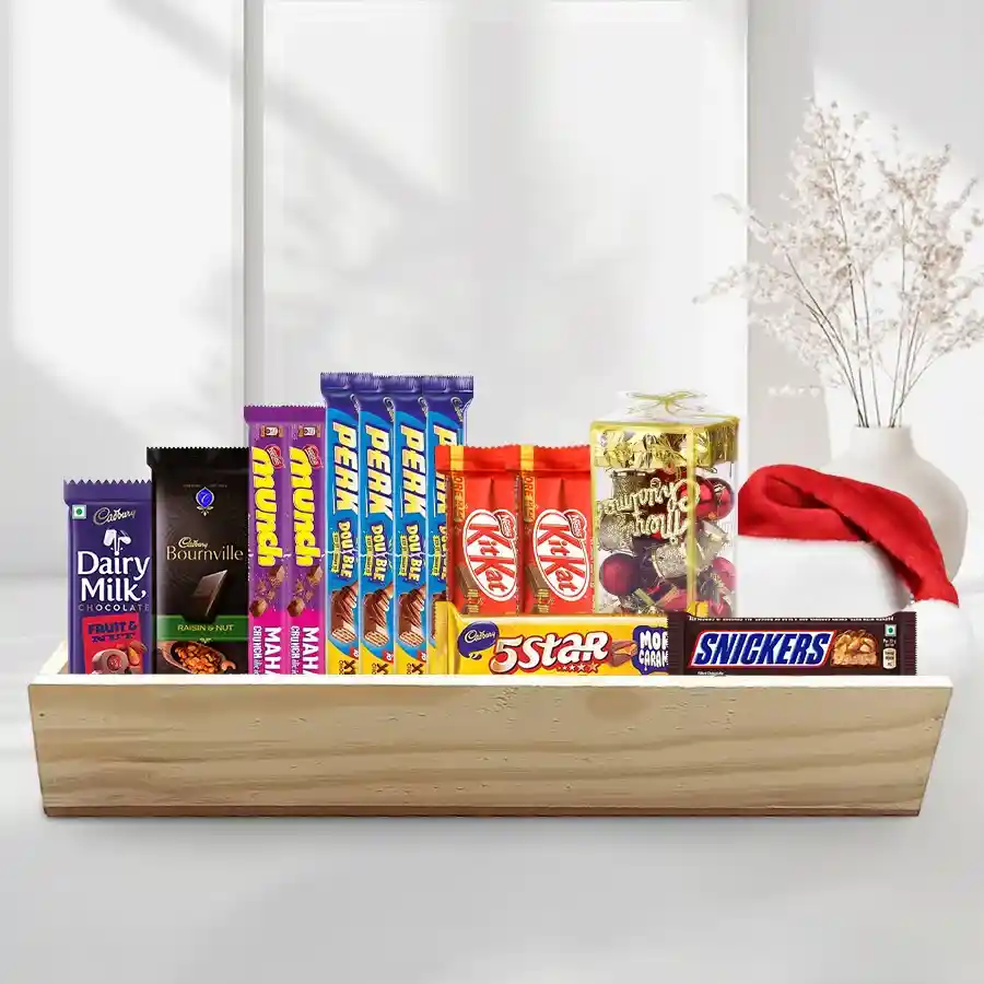 Chocolaty Comfort Christmas Gift Hamper featuring assorted chocolates, a festive decoration cap, and a beautifully designed gift box
