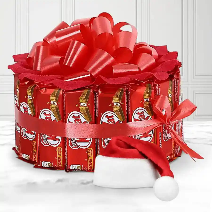 Bustling Joy Kitkat Arrangement featuring 15 Nestle Kit Kat bars and a cute Santa hat, perfect for Christmas celebrations.