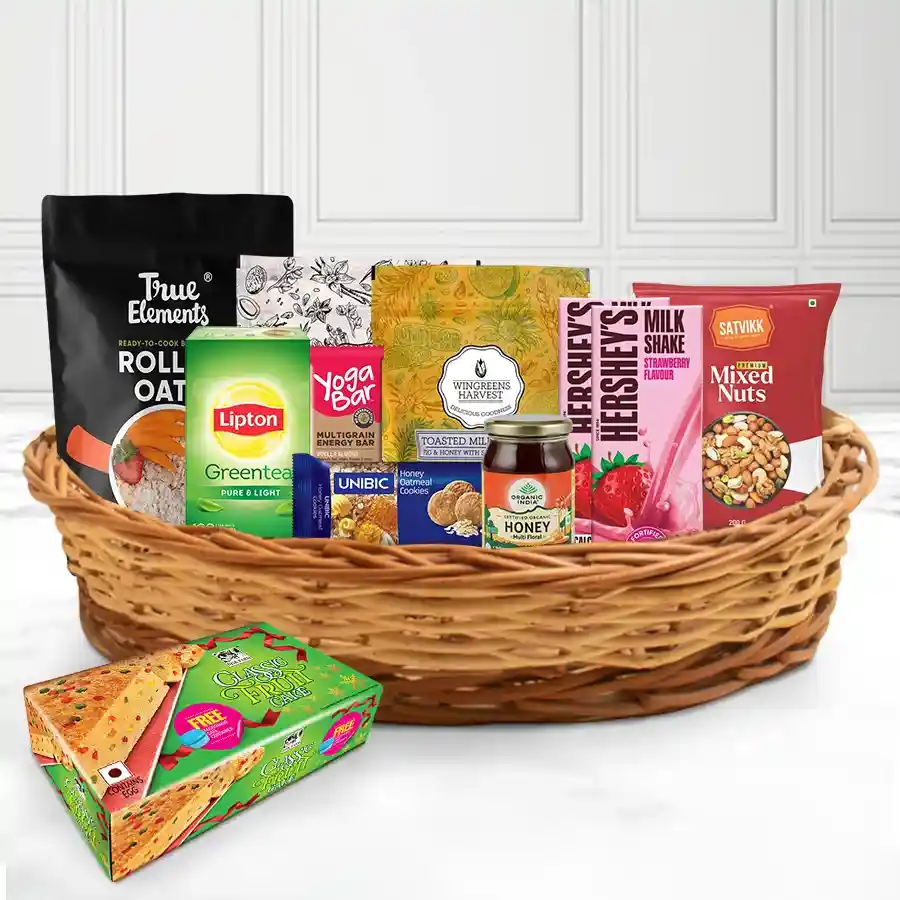 Wholesome X-Mas Savory Gift Basket filled with rolled oats, muesli, strawberry shakes, mixed nuts, honey, oatmeal cookies, green tea, a yoga protein bar, and fruit cake, presented in a reusable basket