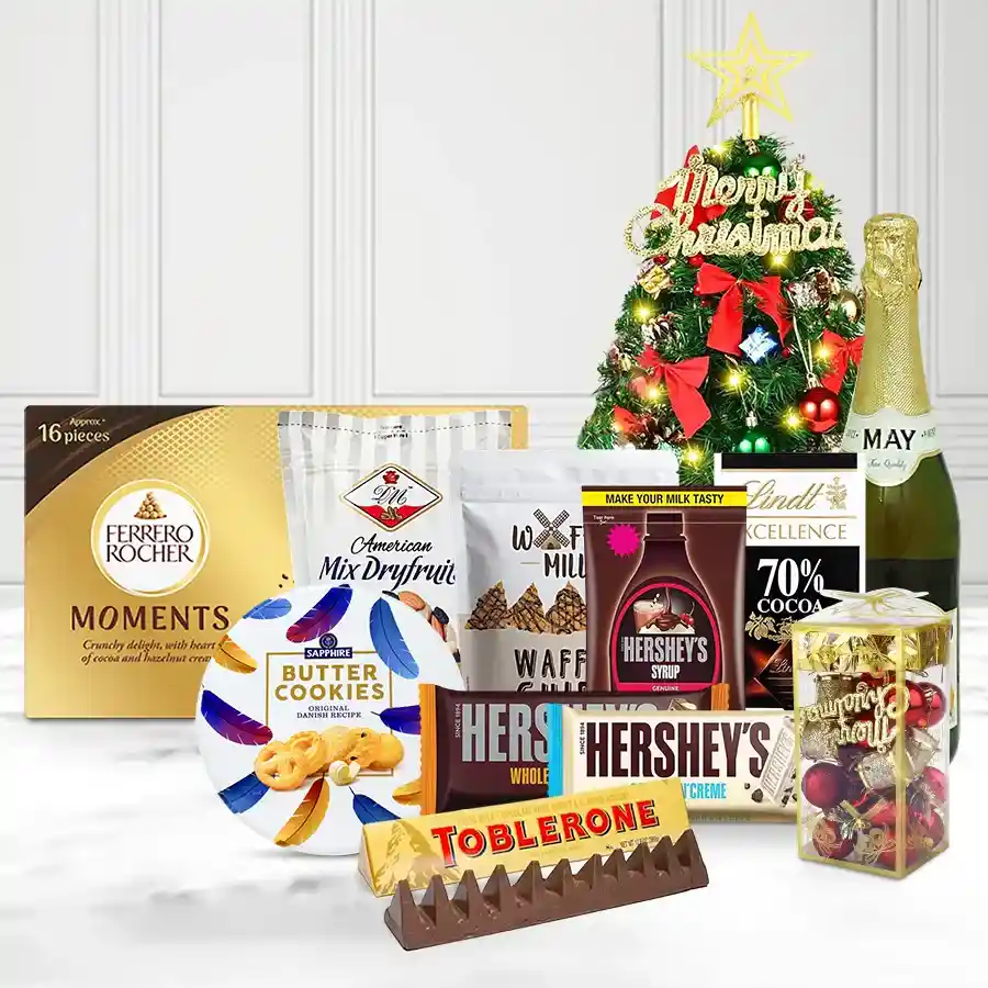Premium Gourmet Hamper filled with festive treats including sparkling fruit juice, mixed nuts, chocolates, cookies, and holiday decorations.