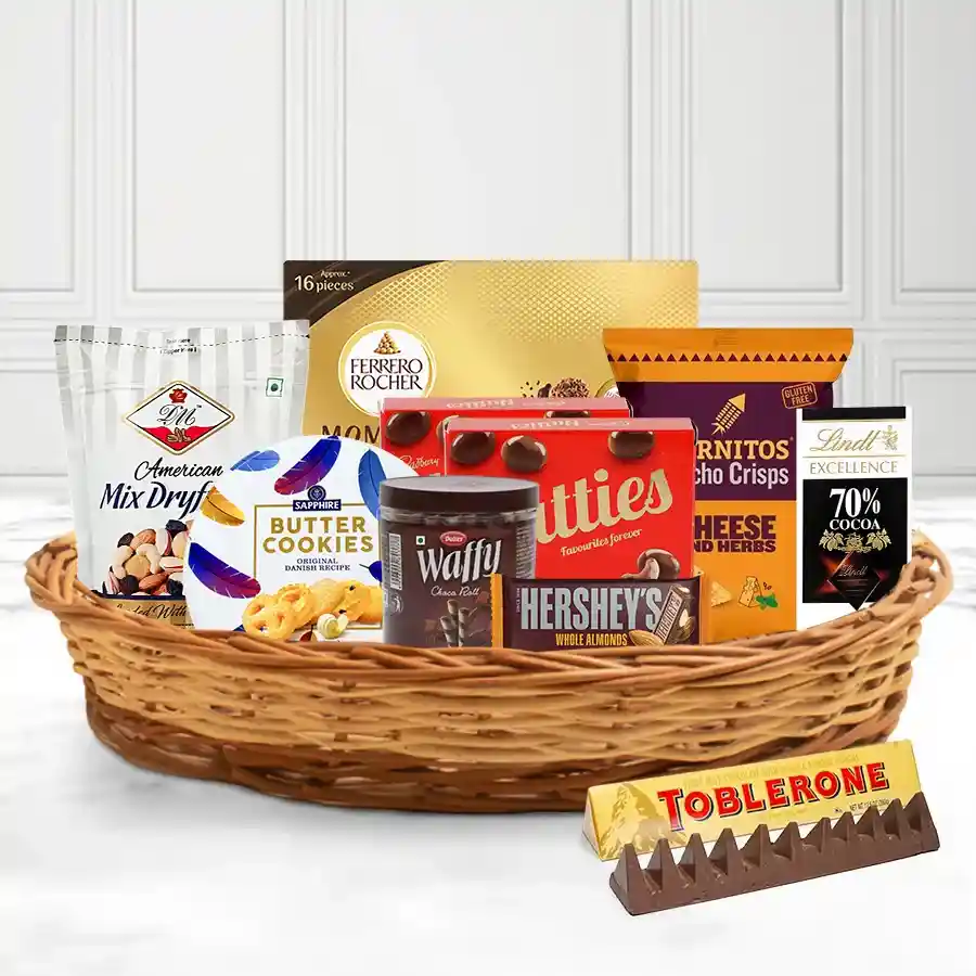 Classy Corporate Treat X-Mas Basket filled with DM Mixed Nuts, Sapphire Cookies, Dukes Wafers, Hershey’s and Toblerone chocolates, Nutties, Cornitos, Ferrero Moments, and a Lindt Excellence Dark Chocolate Bar, beautifully arranged in a reusable gift basket.